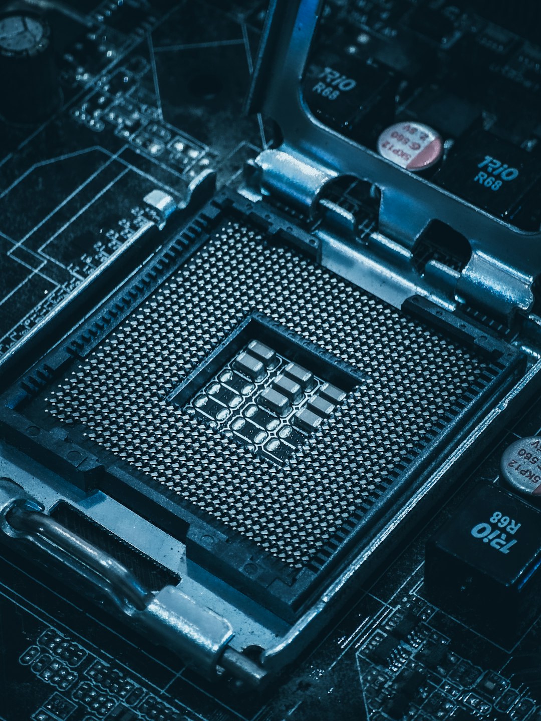 Close-up of an empty CPU socket on a computer motherboard, the packaged-chip stage where Malaysia's industry is strongest