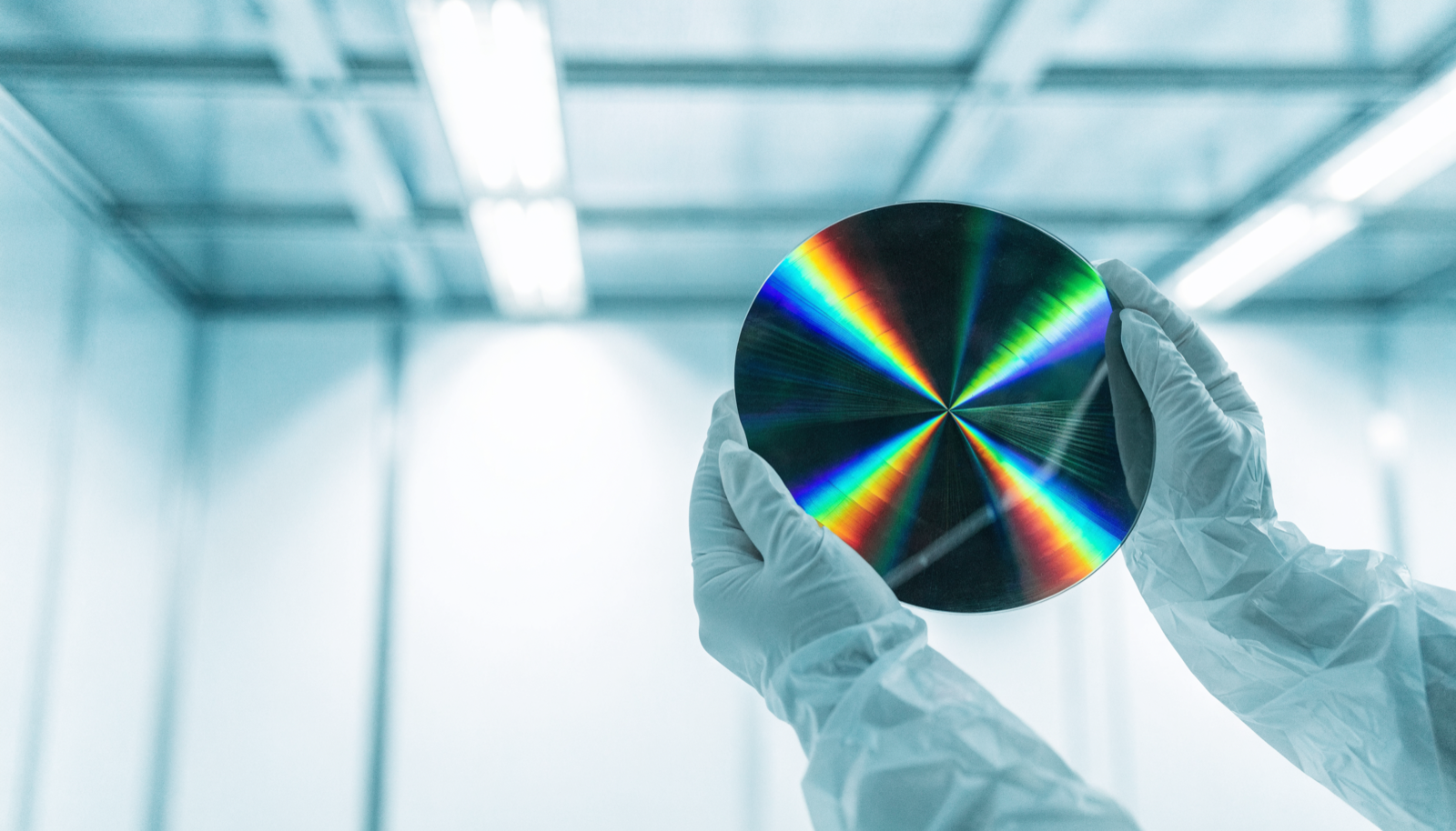 A silicon wafer held in a semiconductor cleanroom A silicon wafer held in a semiconductor cleanroom