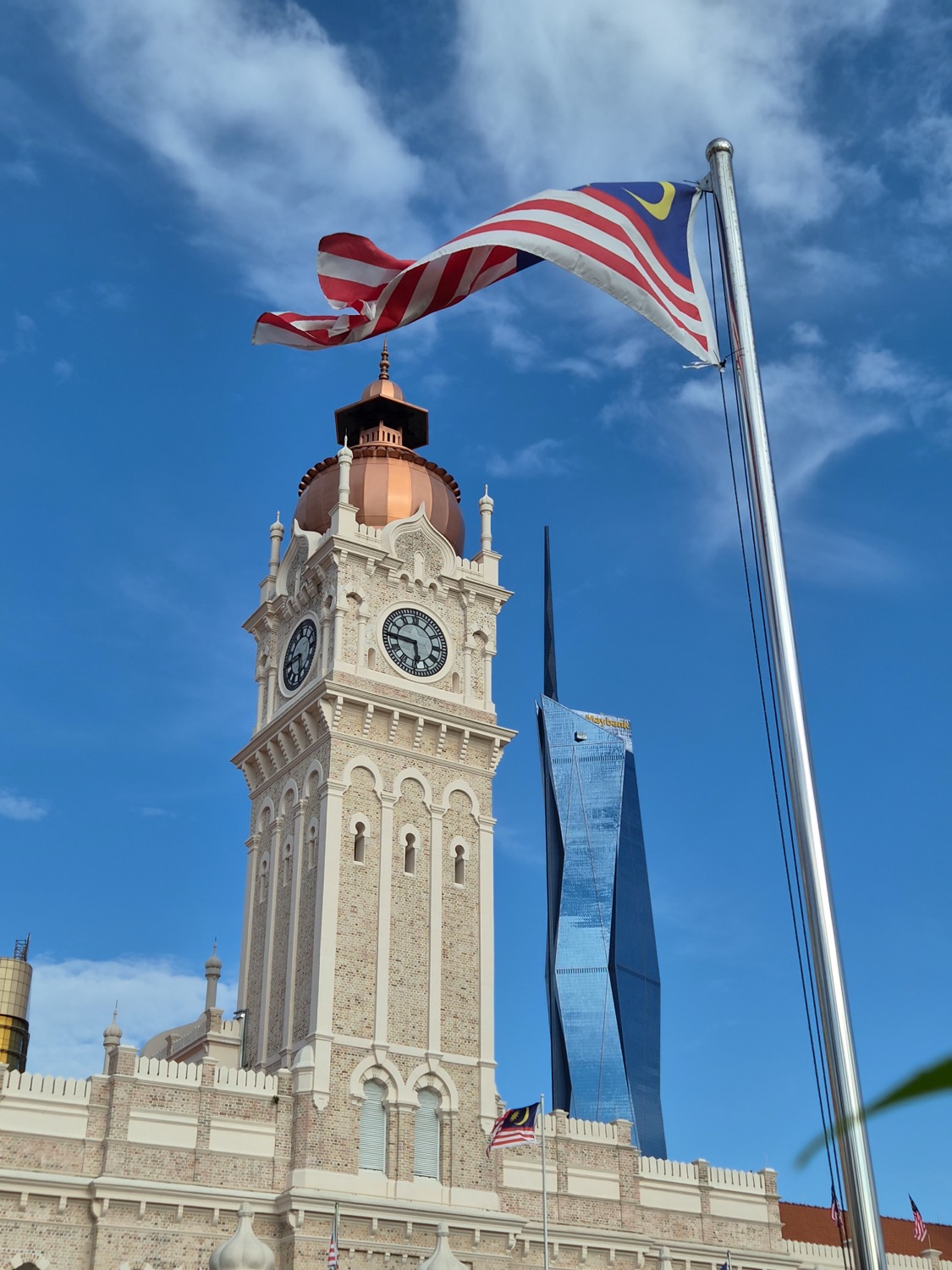 The Dataran Merdeka clock tower, the flag and Merdeka 118 behind it, shot on the Galaxy Z Flip8 The Dataran Merdeka clock tower, the flag and Merdeka 118 behind it, shot on the Galaxy Z Flip8