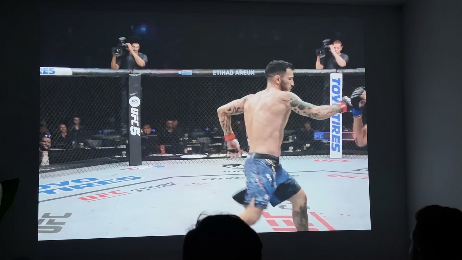 XGIMI Horizon 20 Pro in a living room Viewers watching a UFC game projected on a wall by the XGIMI Horizon 20 Pro