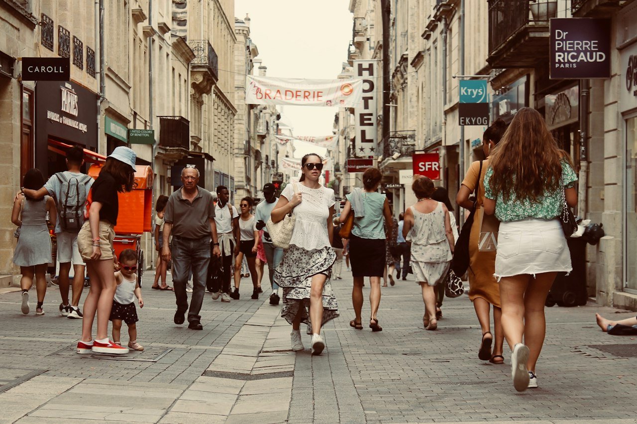 Pedestrians walking along a busy public street
