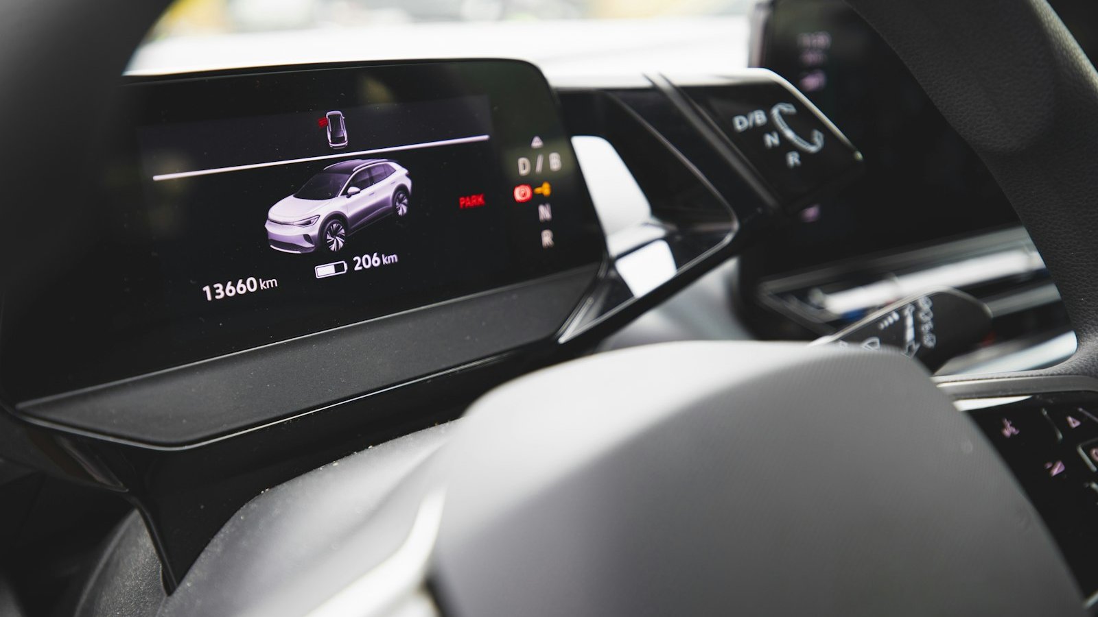 An electric vehicle instrument cluster showing remaining driving range and battery level