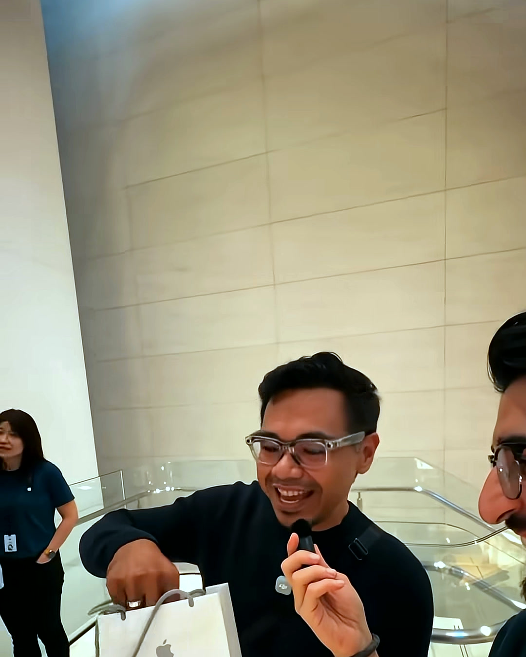 A buyer at Apple TRX holding his new iPhone 18 Pro in Burgundy A buyer at Apple TRX holding his new iPhone 18 Pro in Burgundy