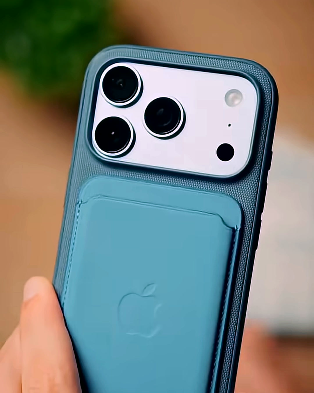 iPhone 18 Pro Max in a case with a card pocket, held up by its own wrist strap iPhone 18 Pro Max in a case with a card pocket, held up by its own wrist strap