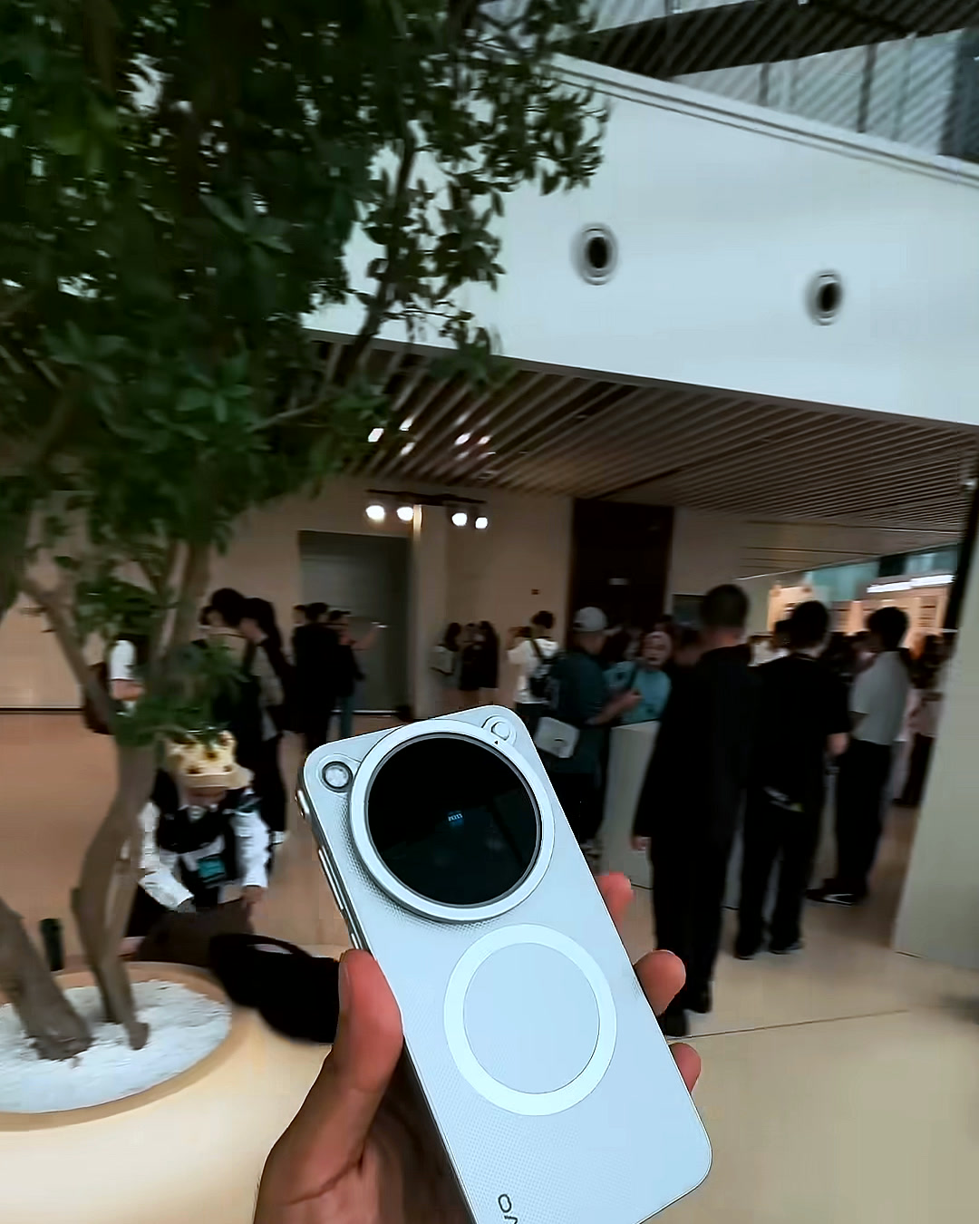 Holding the vivo X500 Pro Max with the lens attached while walking through its specs Holding the vivo X500 Pro Max with the lens attached while walking through its specs