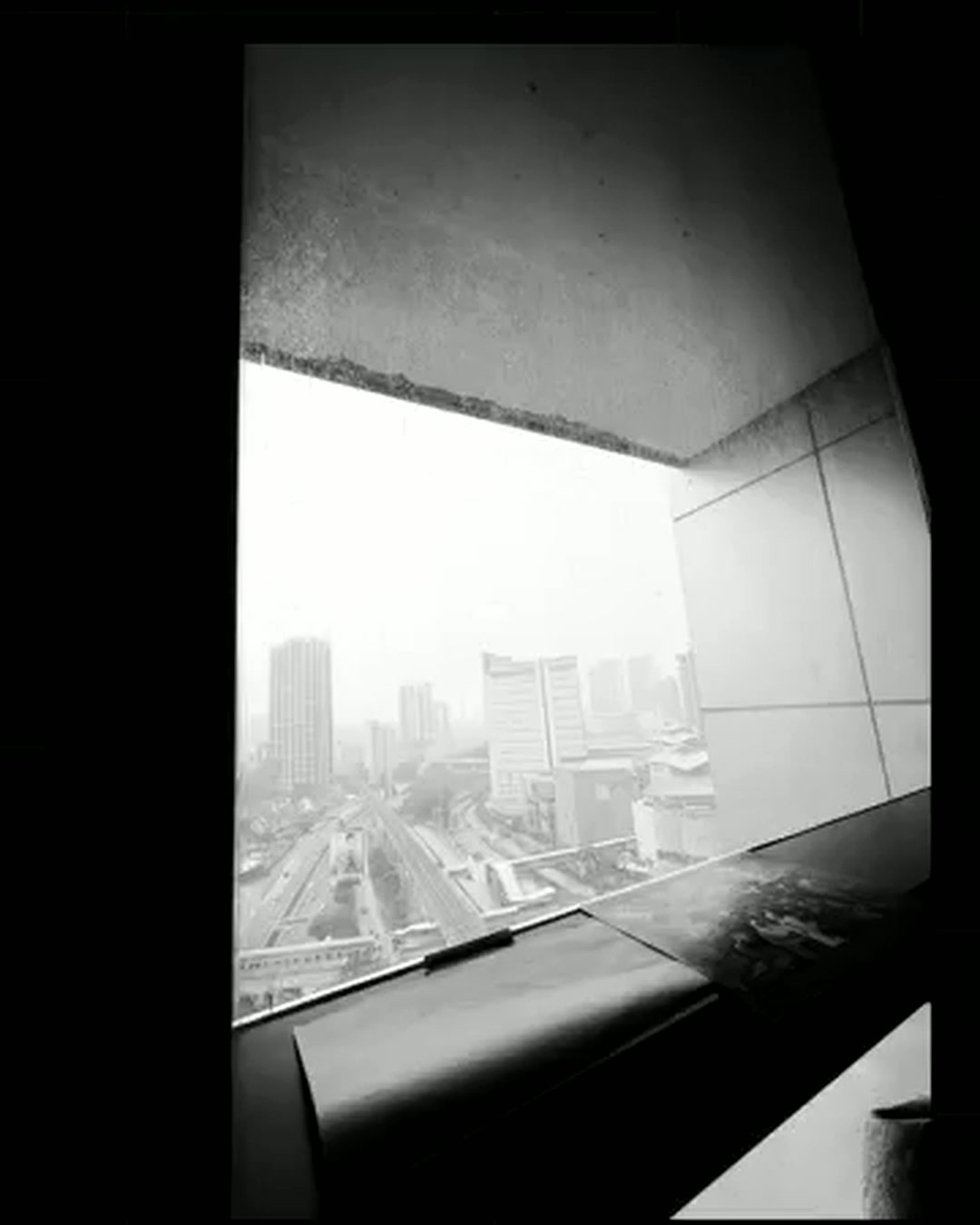 A printed still of the shot held up against the real hazy Kuala Lumpur skyline it was taken from A printed still of the shot held up against the real hazy Kuala Lumpur skyline it was taken from