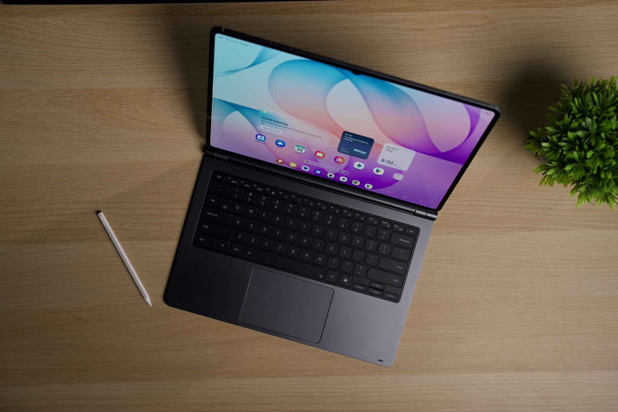 Top-down view of the Galaxy Tab S12 Ultra attached to a keyboard with a large trackpad, with an S Pen at the left