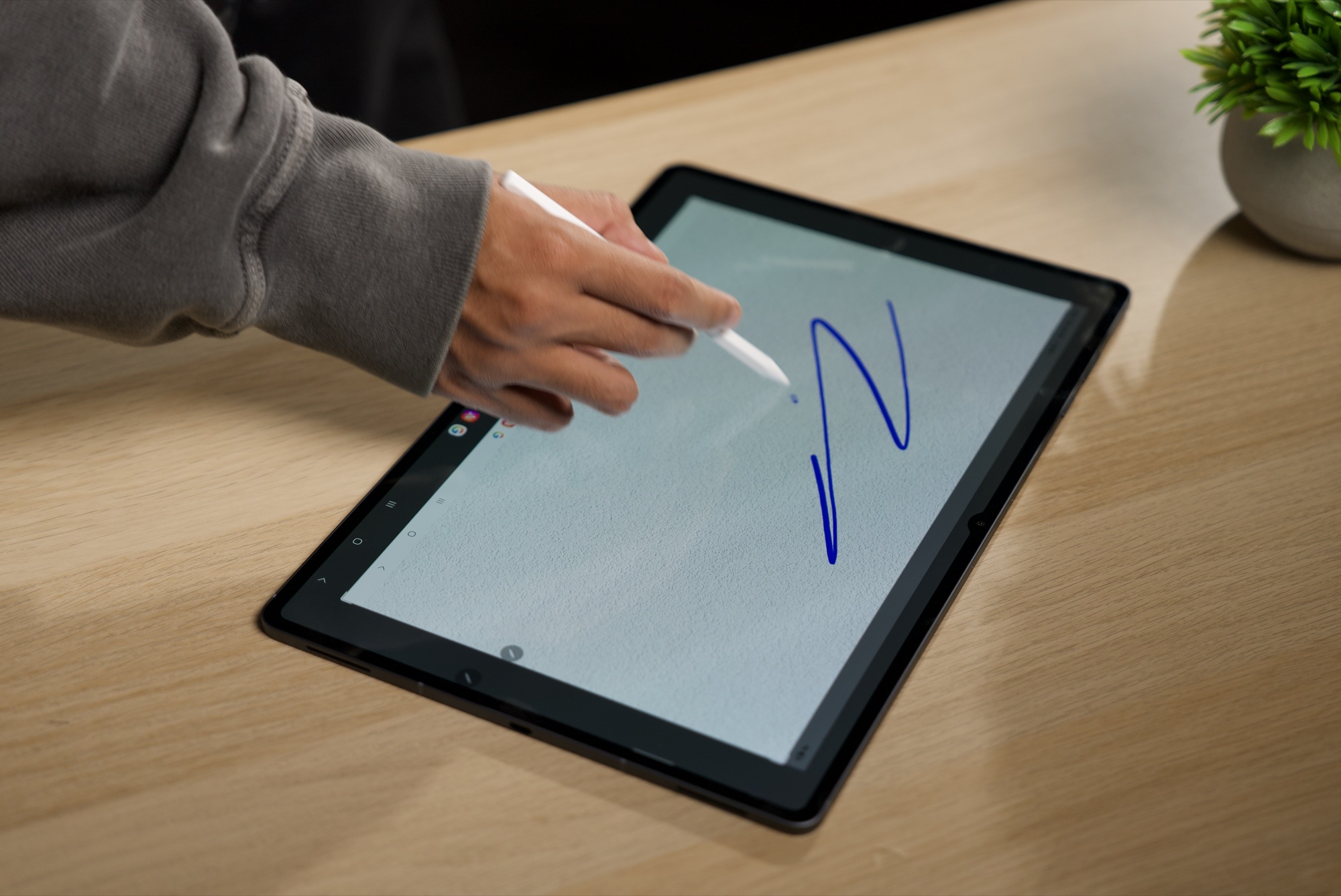 The S Pen drawing a blue stroke on the screen of the Galaxy Tab S12 Ultra