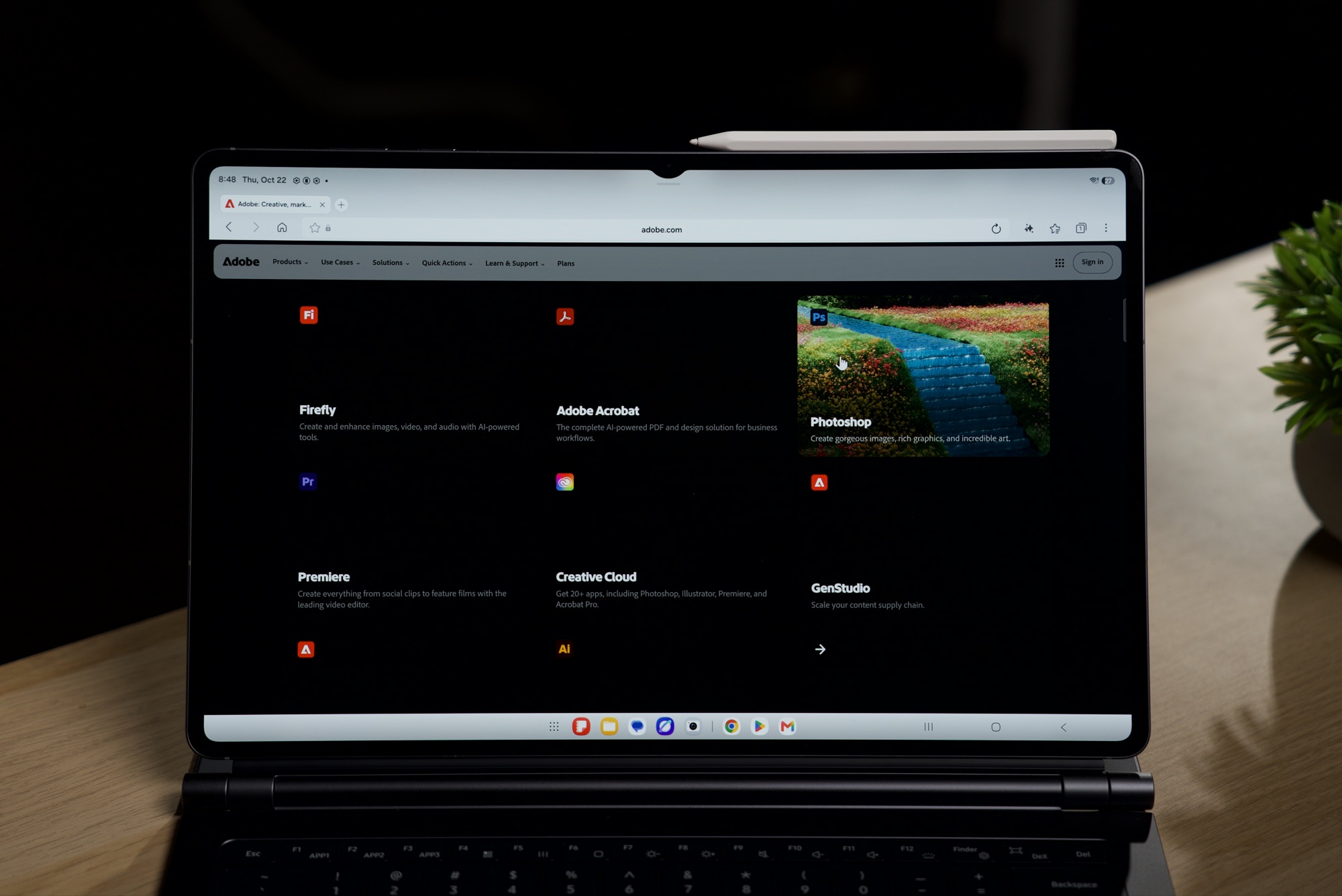 Adobe's website open on the Galaxy Tab S12 Ultra with the Photoshop tile on screen, tablet attached to a keyboard