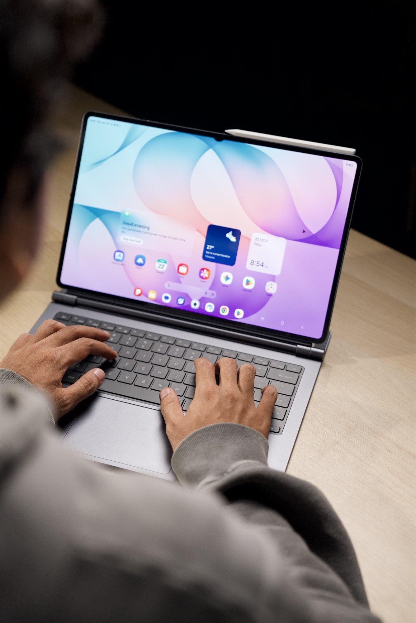 A person typing on the Galaxy Tab S12 Ultra with a keyboard attached,
