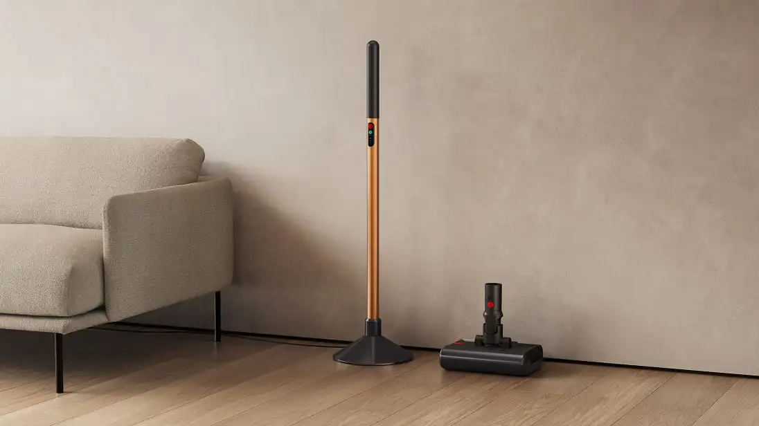 Dyson PencilWash against living room wall next to sofa