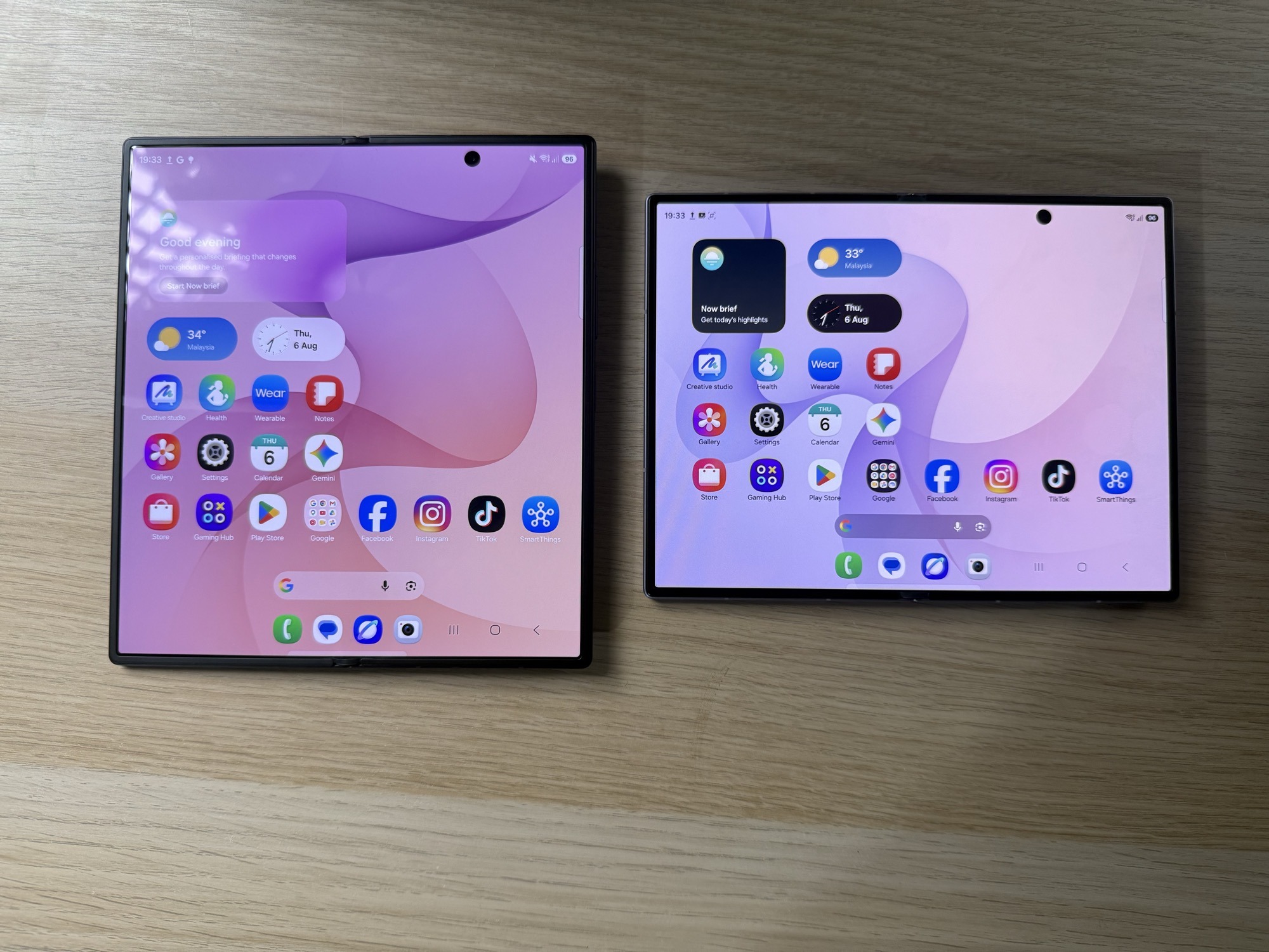 The Fold8 Ultra open beside the standard Fold8, both flat on a desk