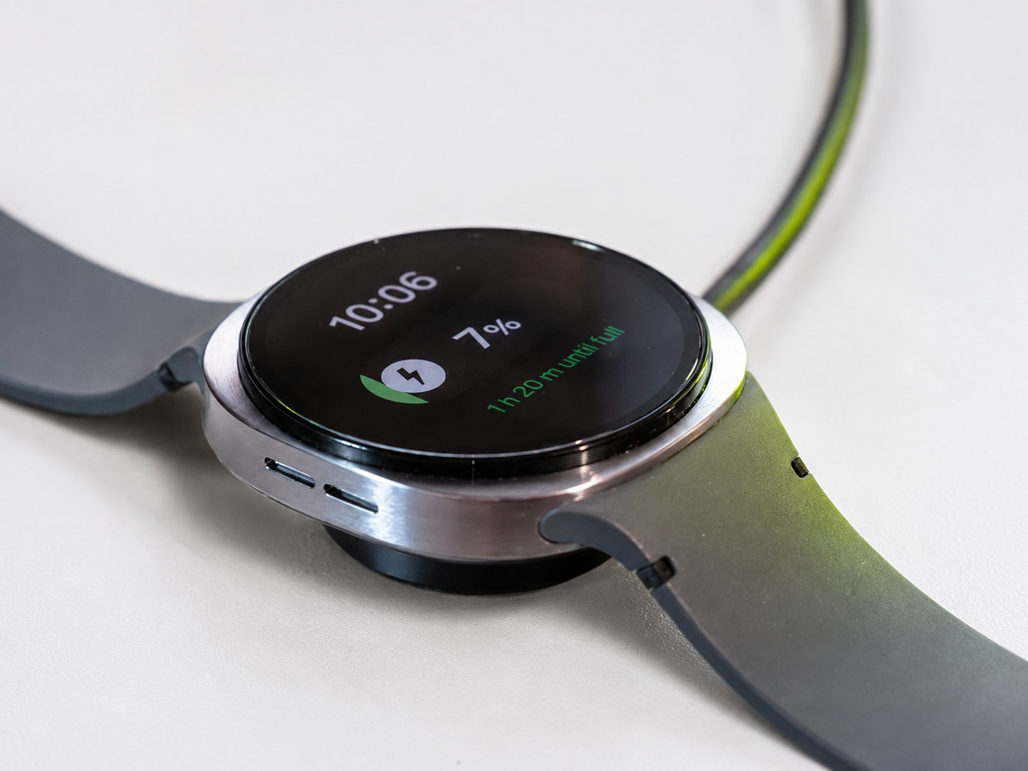 The Galaxy Watch9 on its magnetic charger showing 7 percent