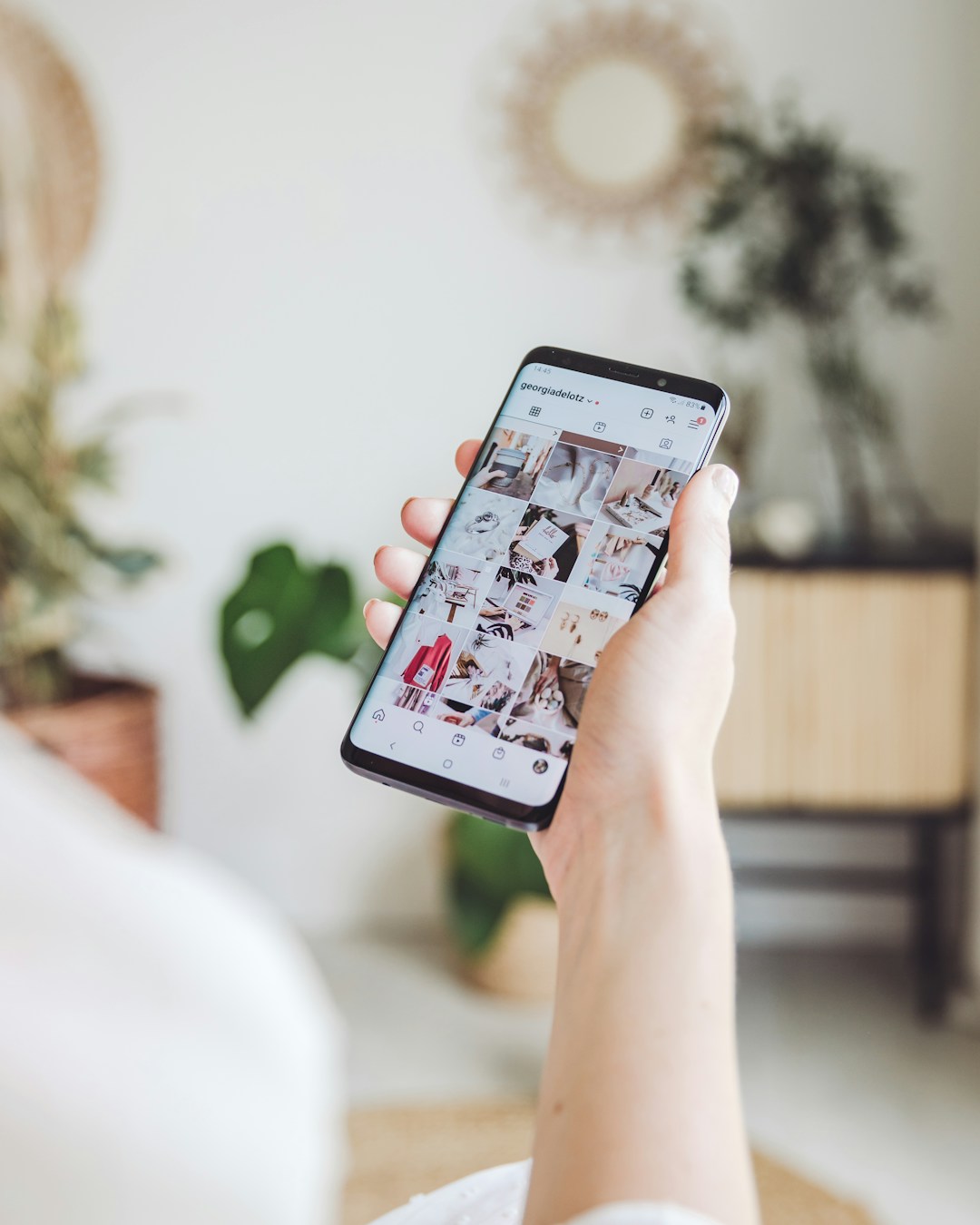 Seseorang memegang telefon pintar dan melayari kandungan