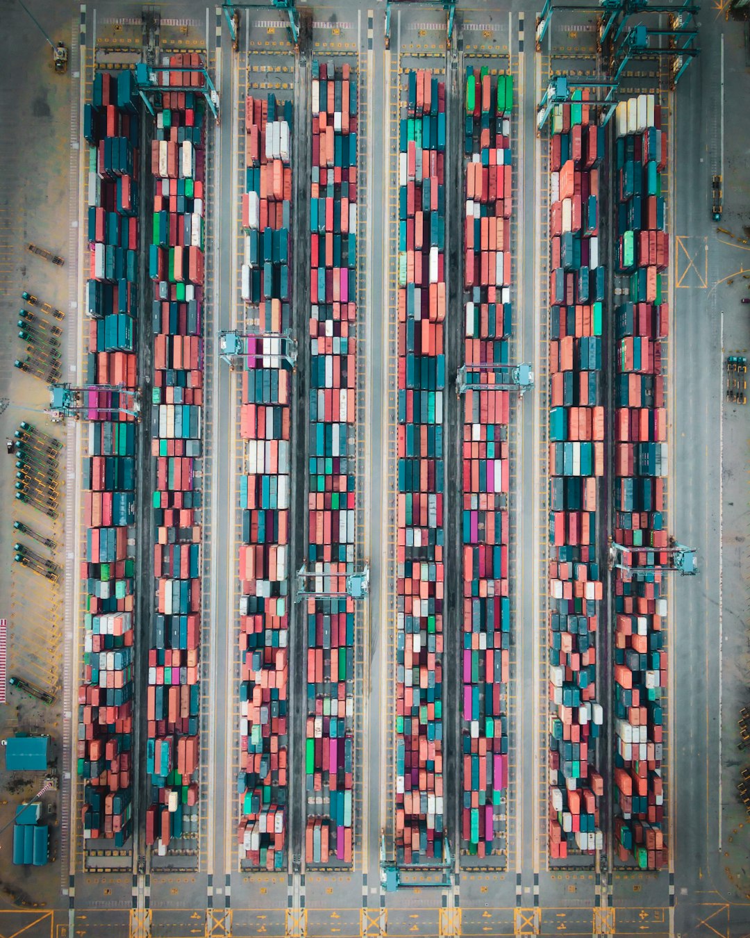 Aerial view of shipping containers stacked at a port terminal