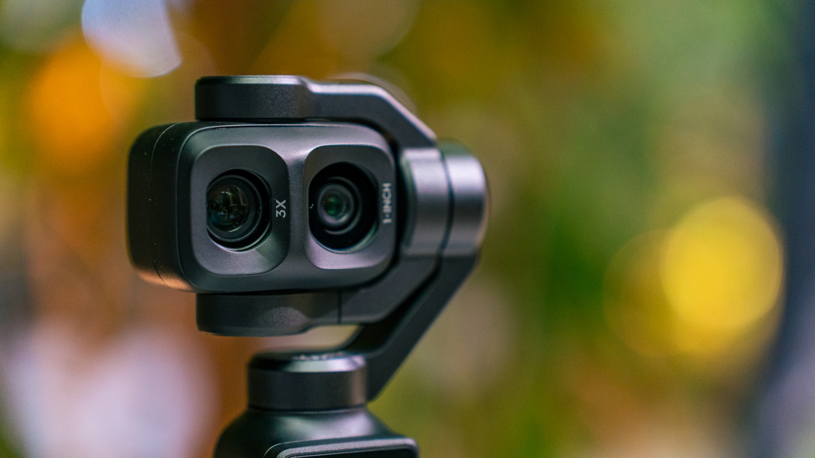 Close-up of the DJI Osmo Pocket 4P showing its two front lenses, marked 3X and 1-INCH
