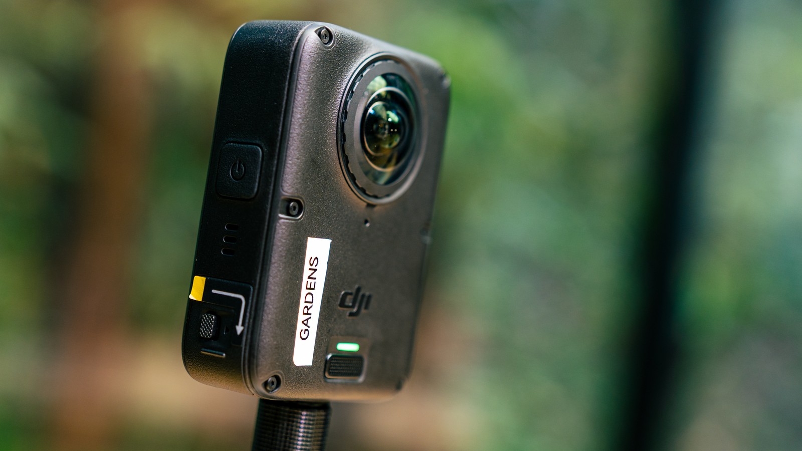 The DJI Osmo 360 II body showing its fisheye lens, power button and replaceable lens ring
