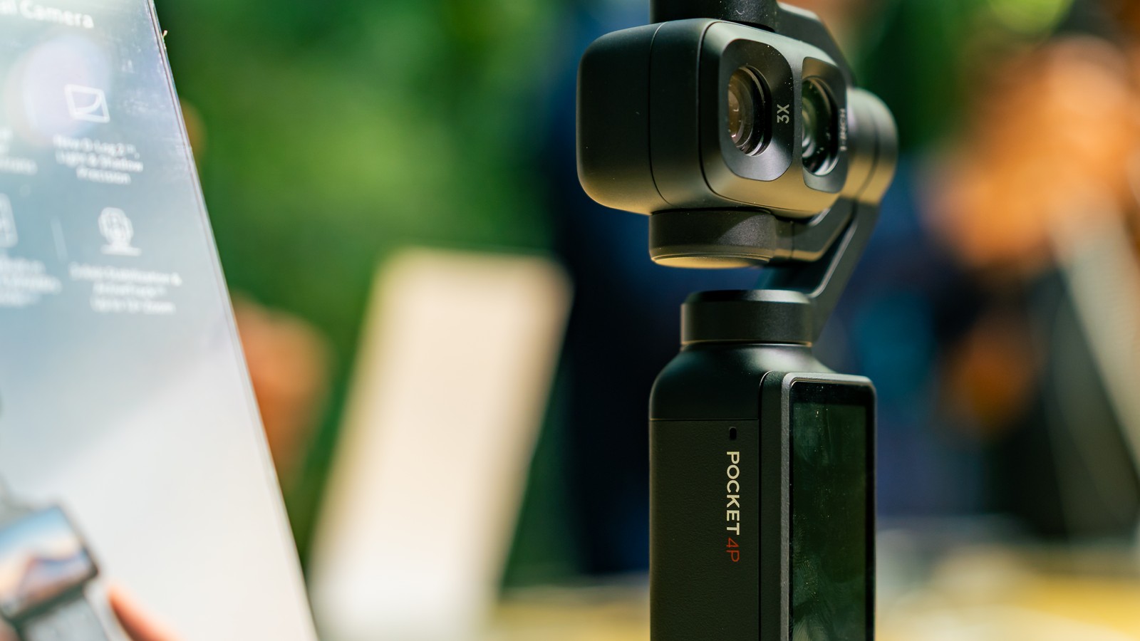 The DJI Osmo Pocket 4P on its gimbal beside a spec board at the Malaysian launch