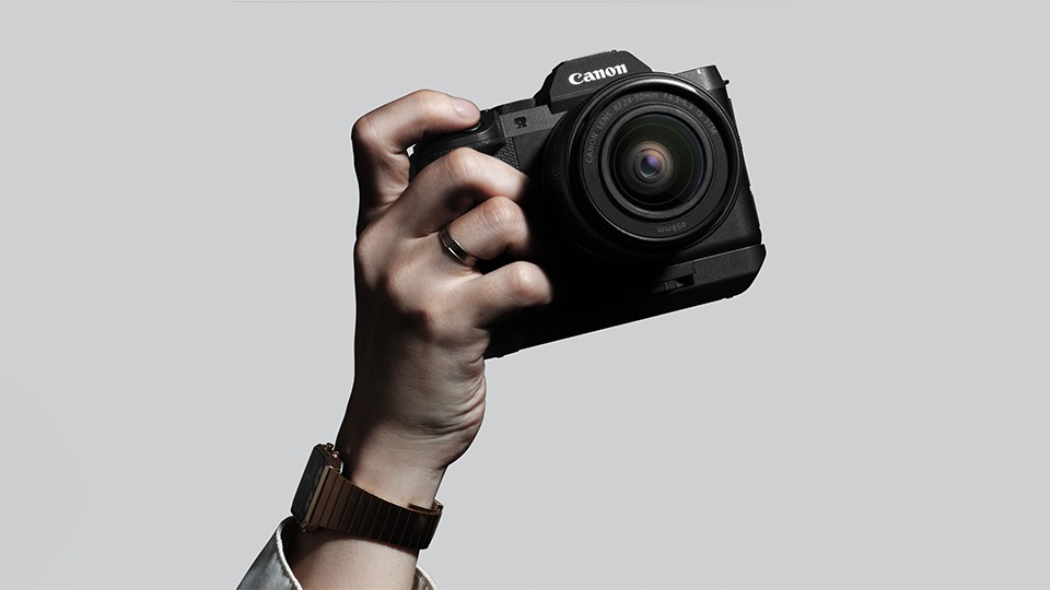 Canon EOS R8 Mark II held in one hand, showing its compact full-frame body