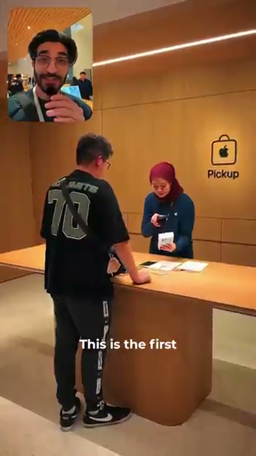 First buyer collecting an iPhone 18 Pro at the Apple TRX pickup counter in Kuala Lumpur