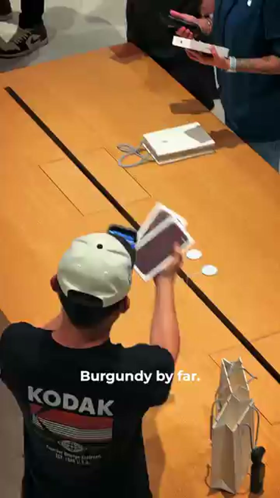 A buyer unboxes his Burgundy iPhone 18 Pro at the Apple TRX counter