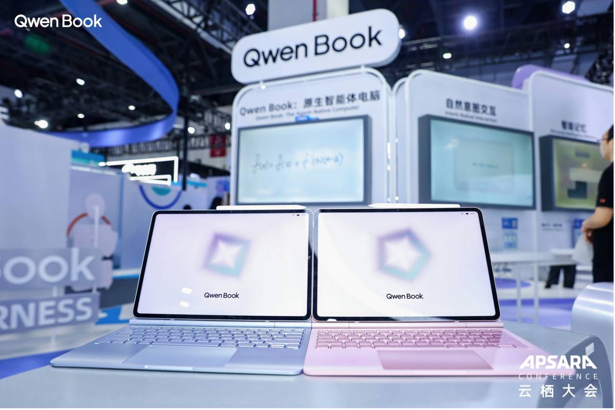 Two Qwen Book agentic computers in blue and pink at Alibaba's Apsara Conference booth