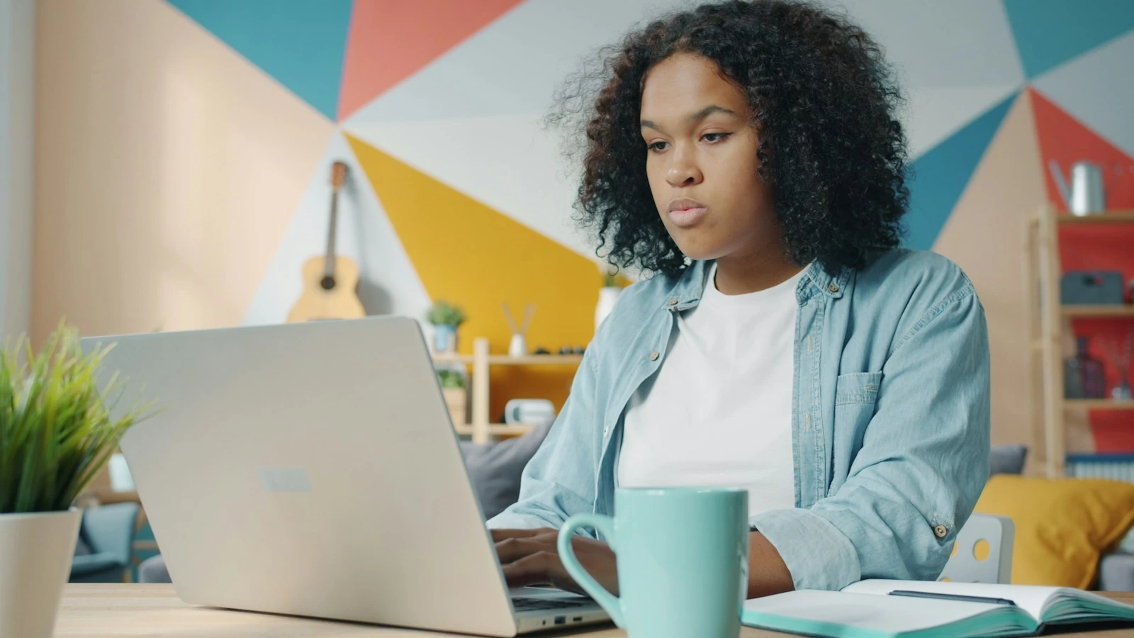A freelancer working on a laptop at home