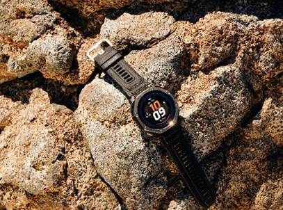 Amazfit T-Rex Dual Solar smartwatch resting on rock outdoors