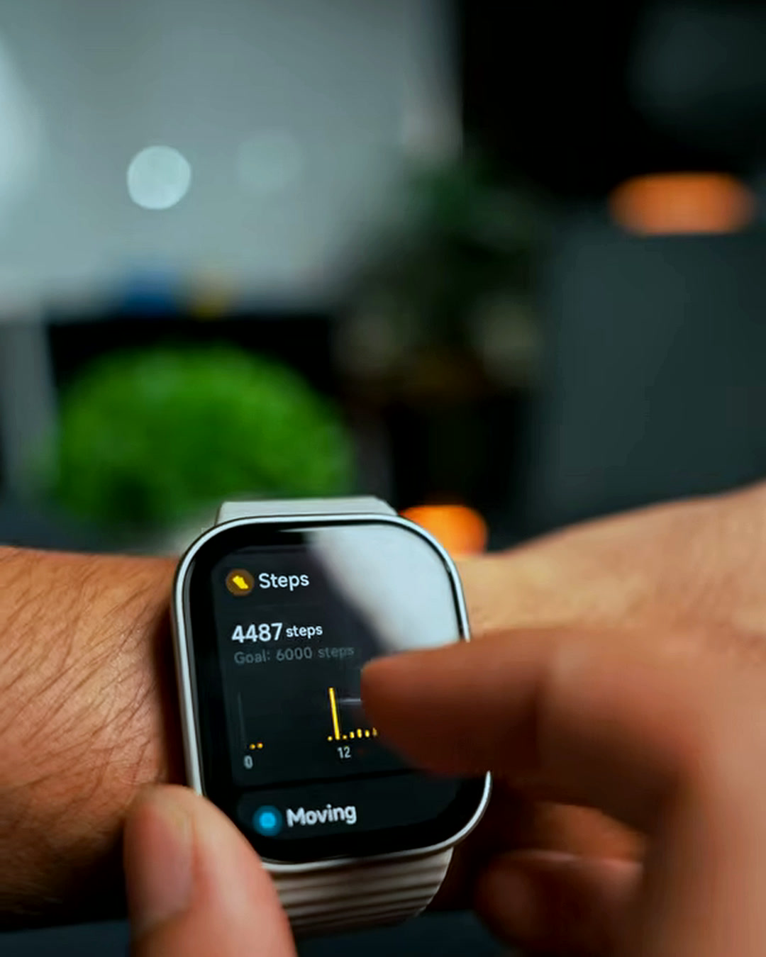 The Redmi Watch 6 Lite's steps screen on wrist, showing 4,487 steps against a 6,000 goal