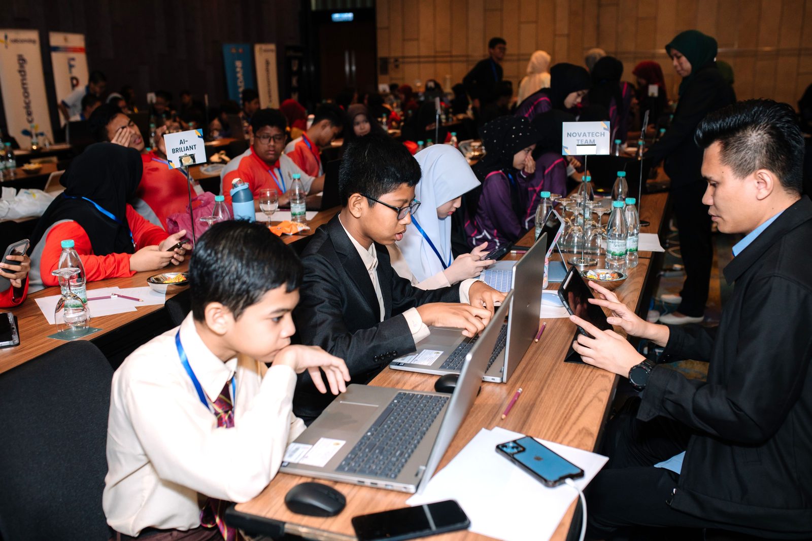 Secondary school students build AI applications on laptops during the AI Muda@NADI Hackathon in Malaysia. Image: CelcomDigi