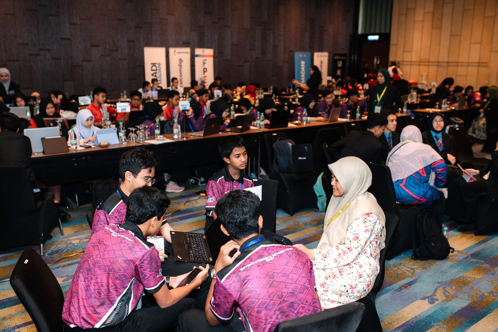 A finalist team works together on their AI project at the AI Muda@NADI national finals. Image: CelcomDigi