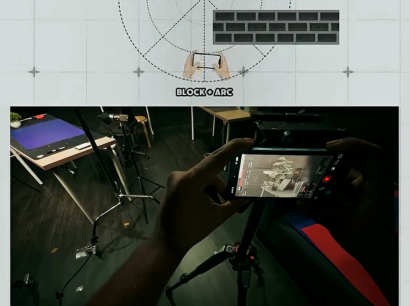 Hands holding a phone on a small tripod, framing the desk setup for a Block + Arc camera movement