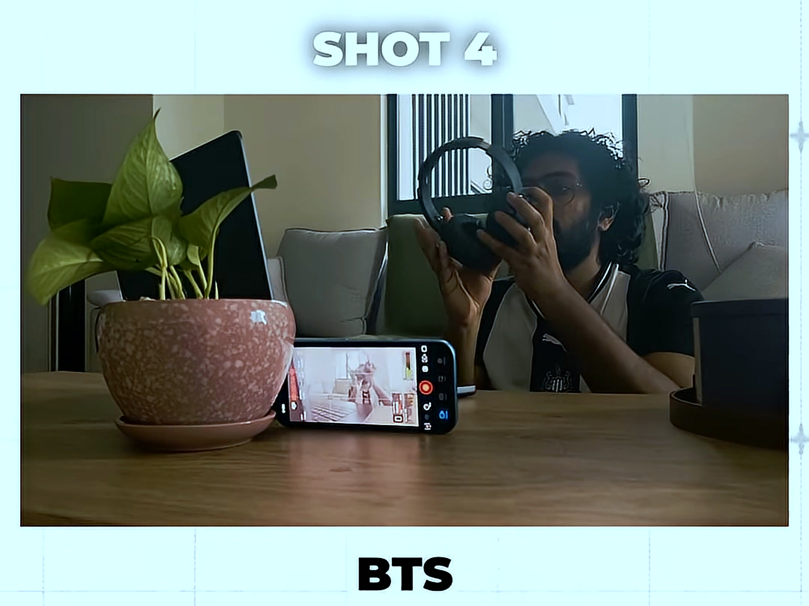 Putting on headphones beside the phone recording the next clip, in the BTS half of Shot 4