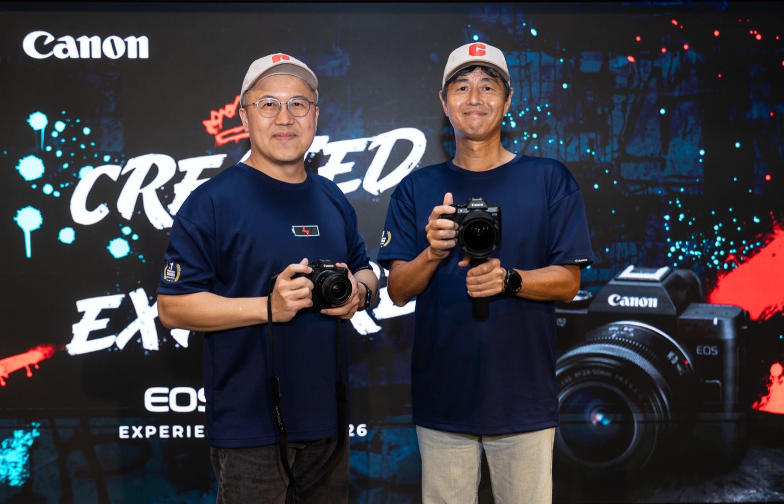 Edward Chang and Masato Yoshiie of Canon Marketing Malaysia holding the EOS R8 Mark II at the tour launch