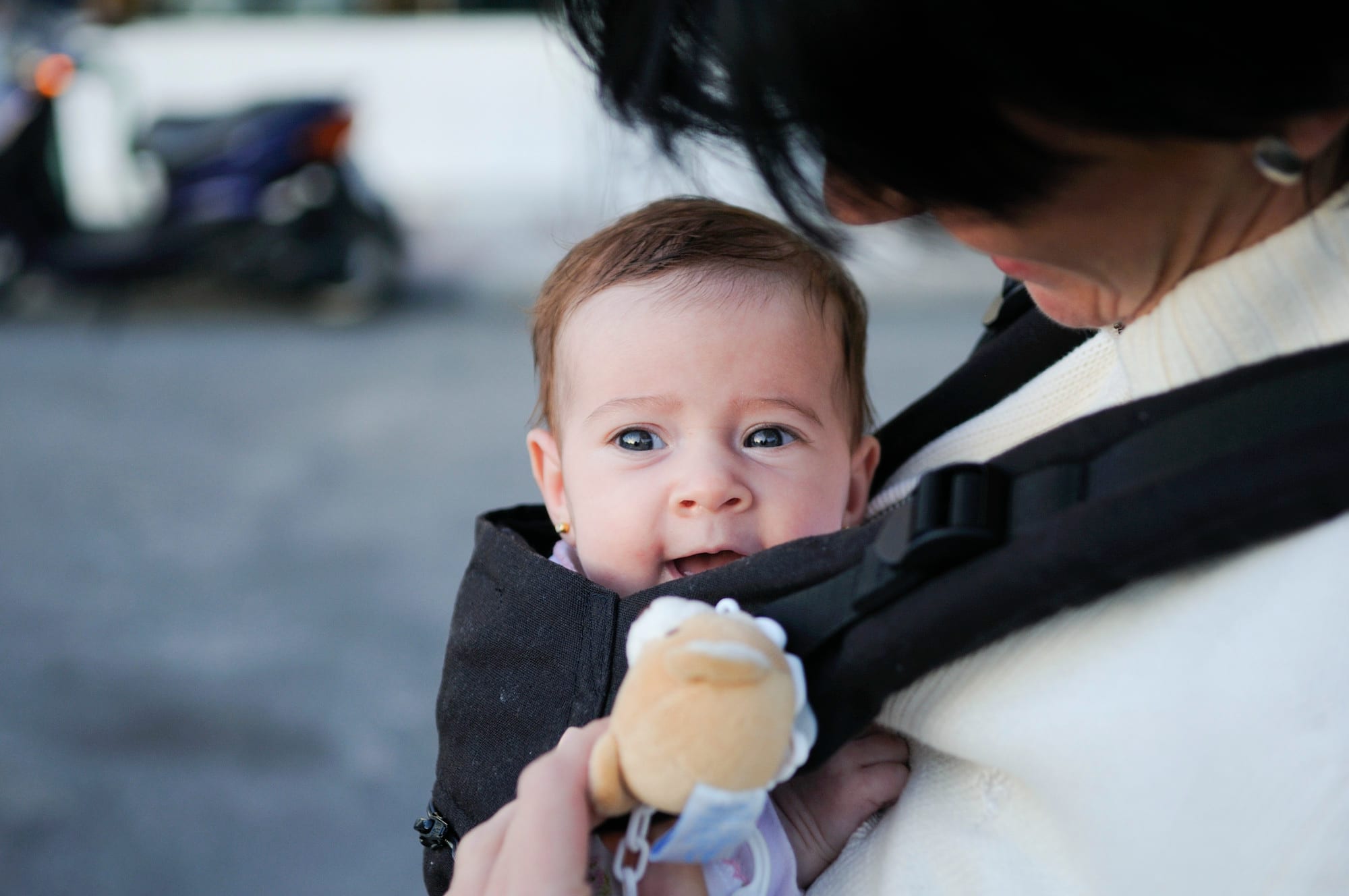 mother-carrying-her-baby-girl-baby-carrier-outdoors.jpg