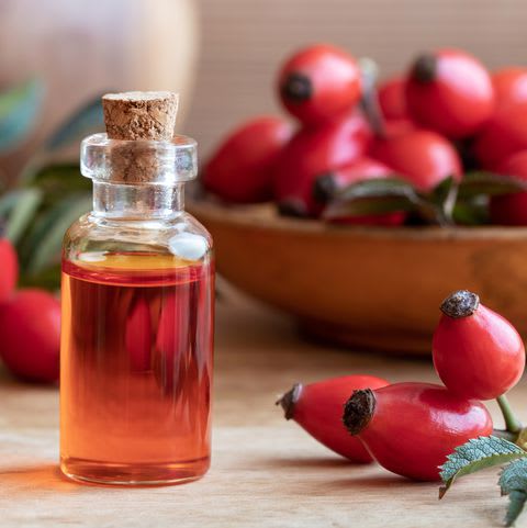 bottle-of-rose-hip-seed-oil-with-fresh-rose-hips-royalty-free-image-1054637112-1545070653.jpg