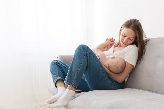 mother-breastfeeding-baby-sitting-sofa-home_67473-304.jpg